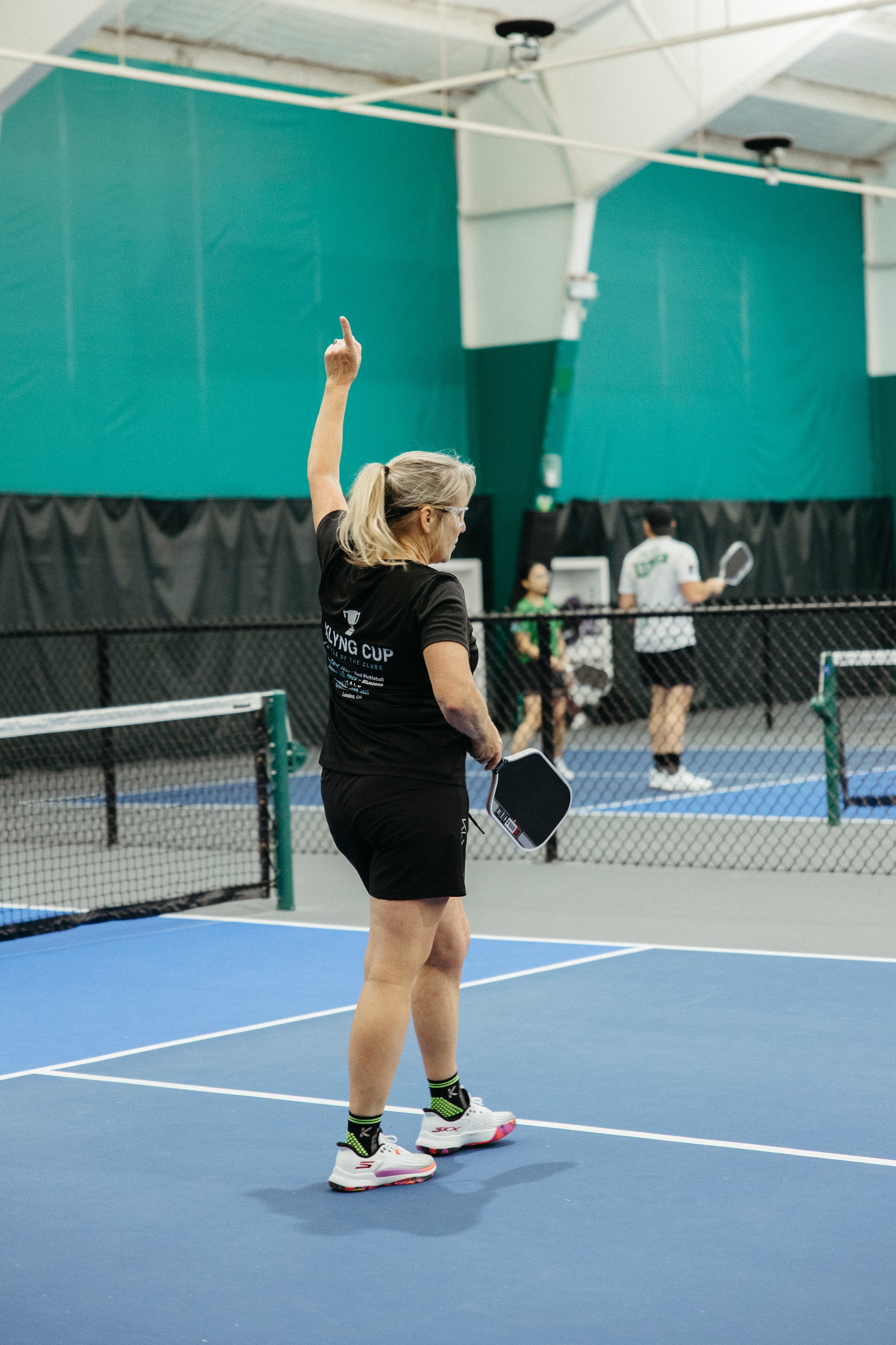 Players celebrating a win with a fist bump after a Klyng Cup match