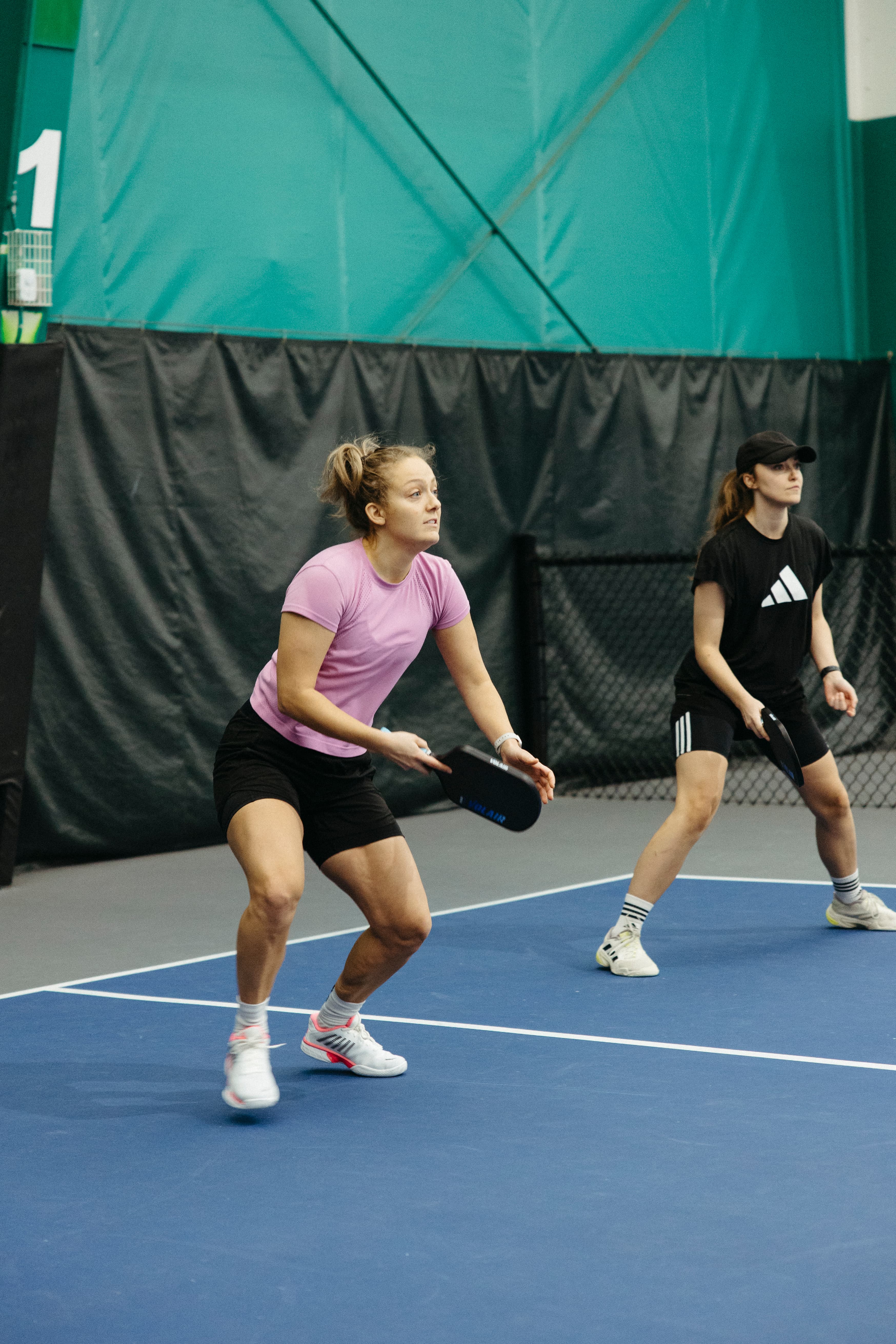 A player stretching for a return at the net